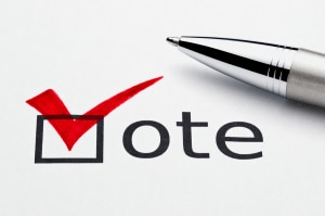 Red checkmark on vote checkbox, pen lying on ballot paper